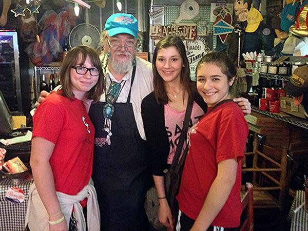 Student media members pose with Bud the Pie Guy at Royers Cafe in Round Top during detour on the way home from ILPC.