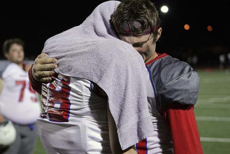 Jacob Jenkins (11) embraces Jacob Allan (12) after a heart-wrenching defeat.