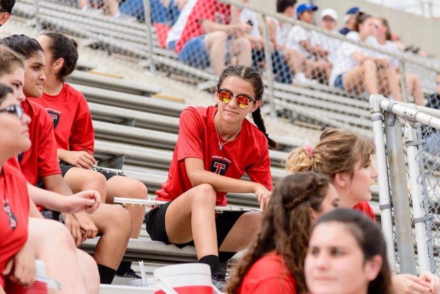Elise Guerra sitting in the bleachers during band rehearsal. 
