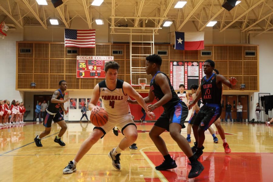 Pryce Burns takes power dribble before attempting layup. Stock Photo