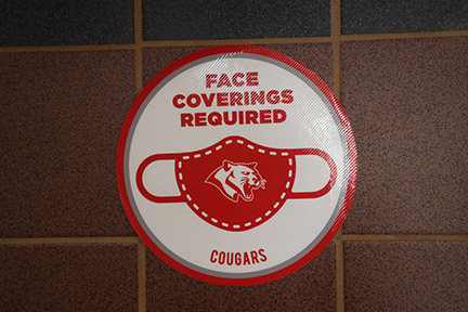 Signs adorn the walls at THS warning students to wear masks and practice social distancing.