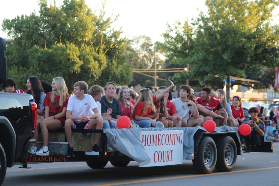 Nominees+for+the+Homecoming+Court+ride+on+a+float+in+the+Homecoming+Parade+in+October.+The+Holiday+Parade+will+follow+a+similar+route.