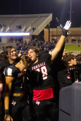 Players celebrate after the Cougars secure a playoff berth with their win against Klein in the final game of the season.
