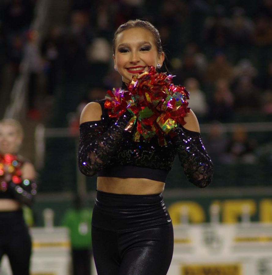 Sophomore Mallorie Albert performs with the Cougar Charms on the field.