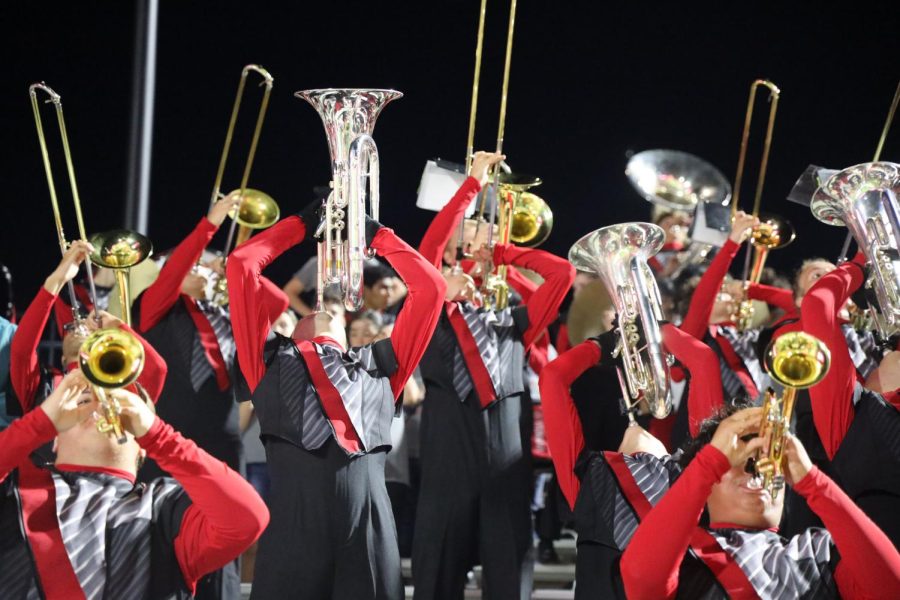 Tomball Cougar Pride Band in the stands at a football game 