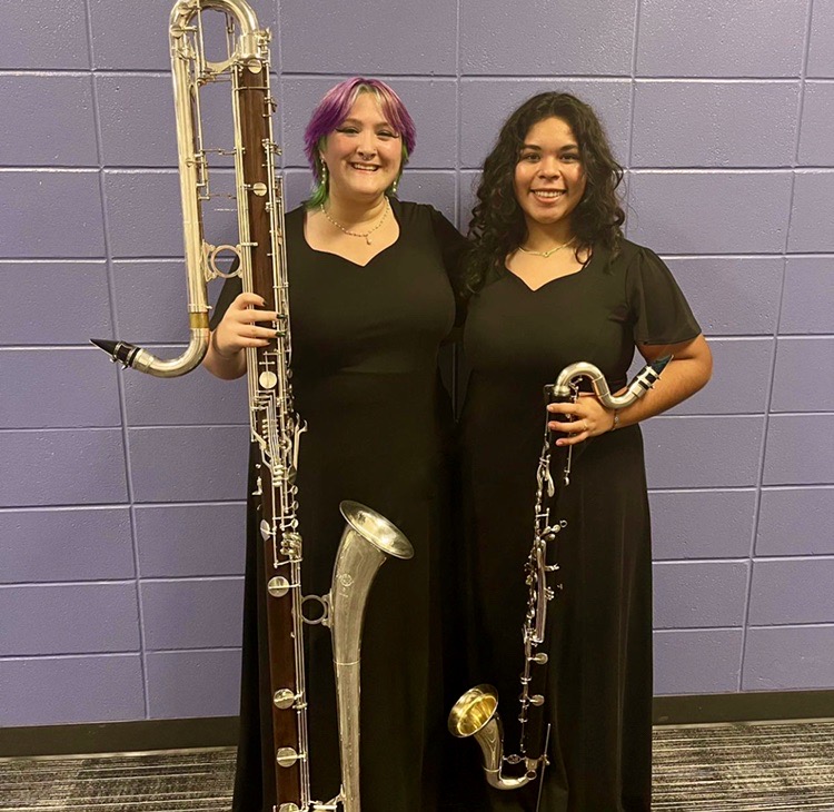Both girls with their instruments ready to perform with the  top Region Band 