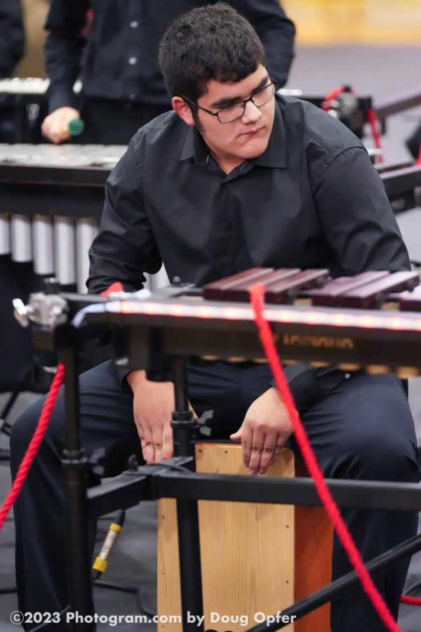 Senior Wyatt Hollingsworth performing the Cajon feature in the show