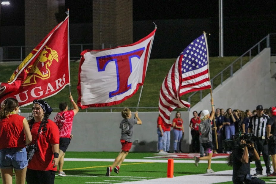 The field crew runs the flags at a football game last year.