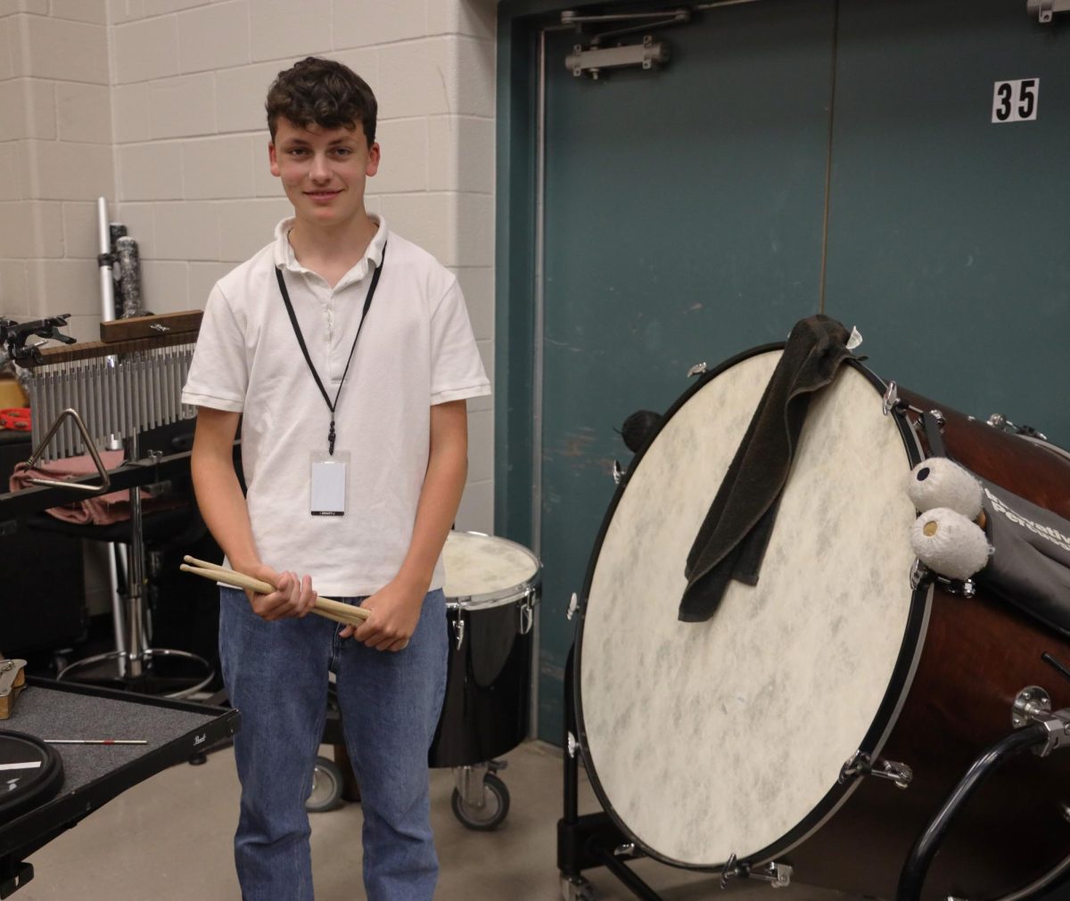 Justus Grewers next to the pairs of equipment that he uses during the marching season