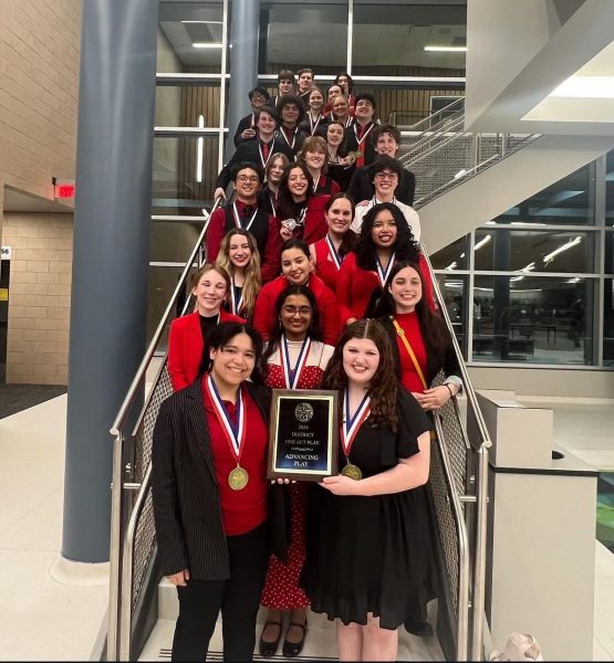 The Tomball STAGE UIL one act play team pose for photo holding the district advancing award 