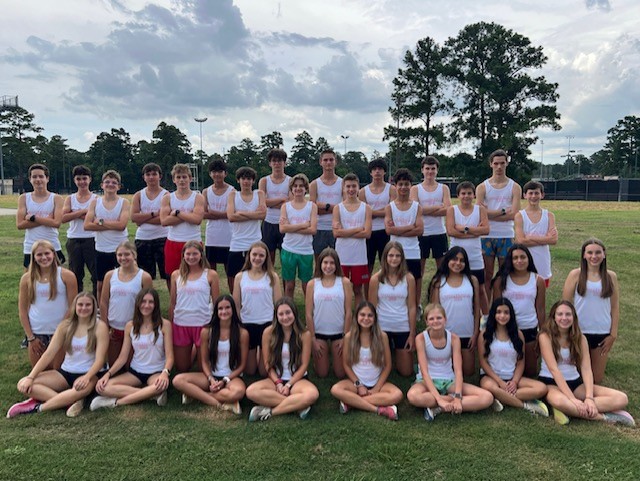 Cross Country Athletes take team photo in practice uniform.