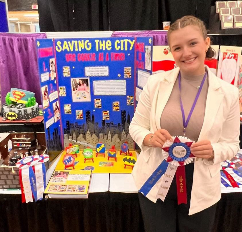 Krystin Conner poses next to her entry to the Skills USA baking competition.