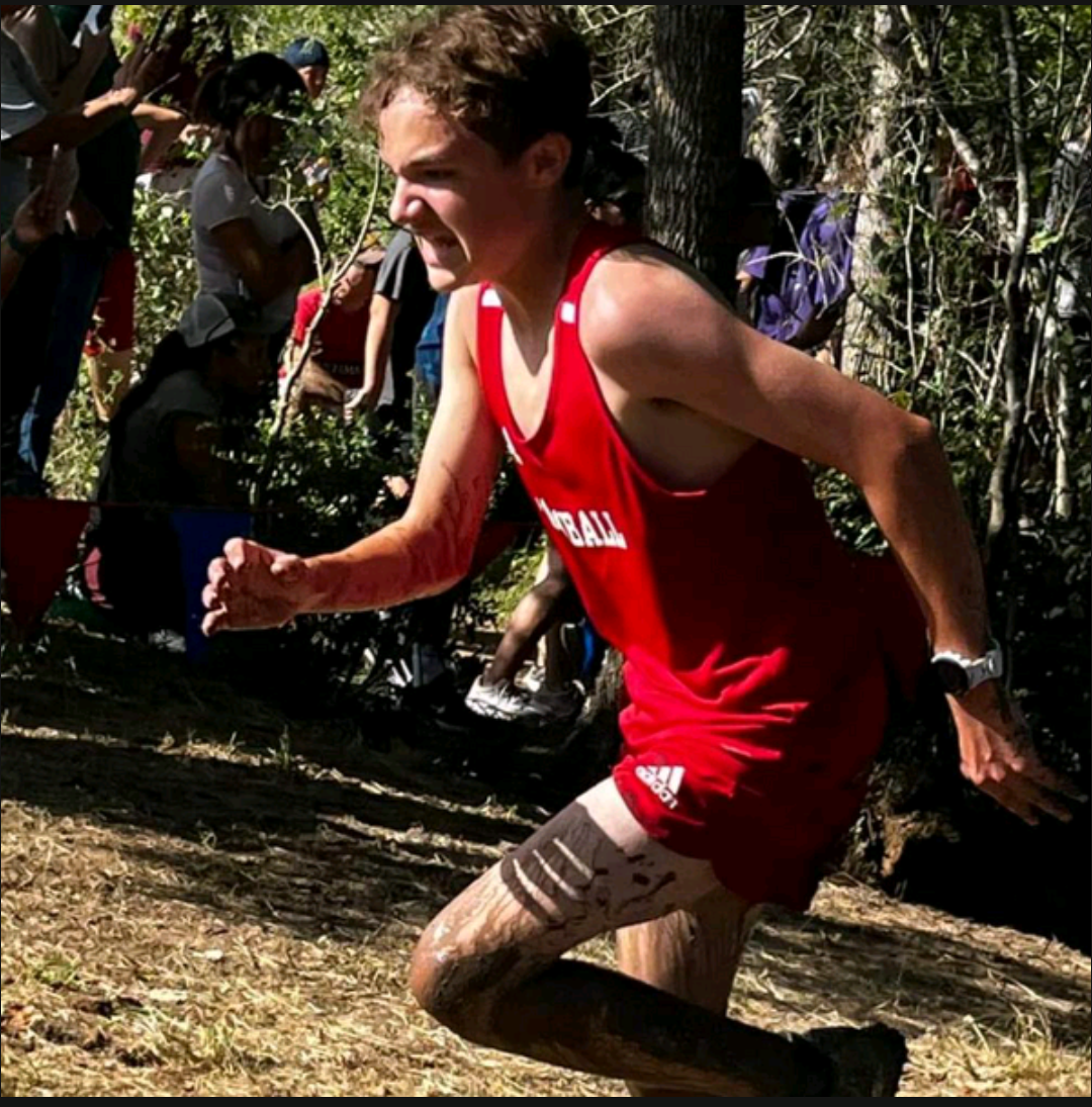 Liam Zimmerman racing at the 2024 Mud, Sweat, and Cheers Cross Country meet.