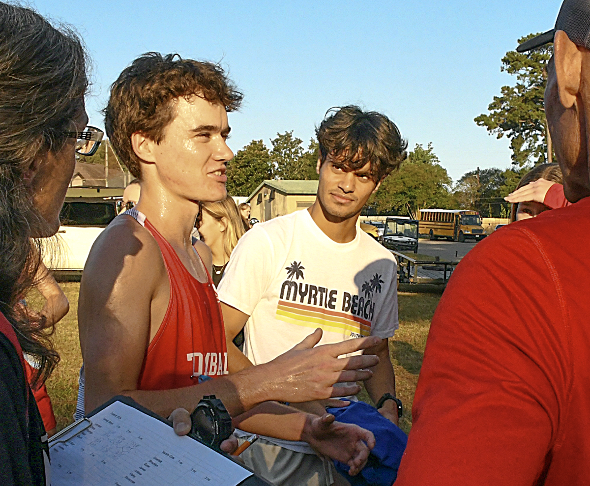 Landon Flies (center left) talking to coaches post run