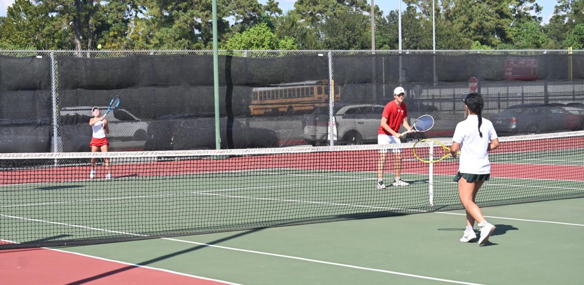 Tomball Tennis mixed doubles starting their match.