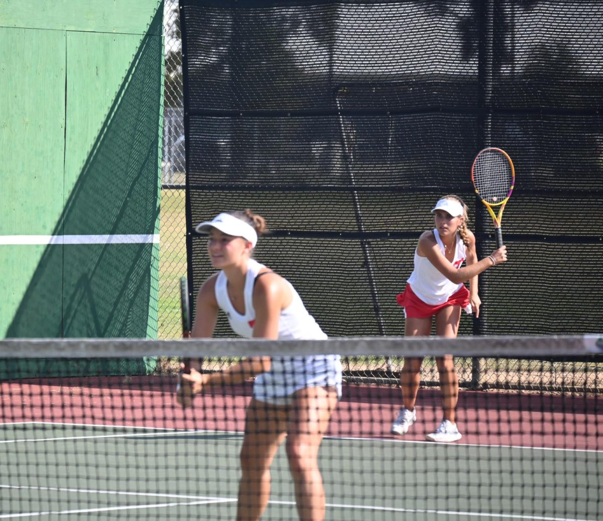 Tomball Tennis girl ready to receive after serving the ball.