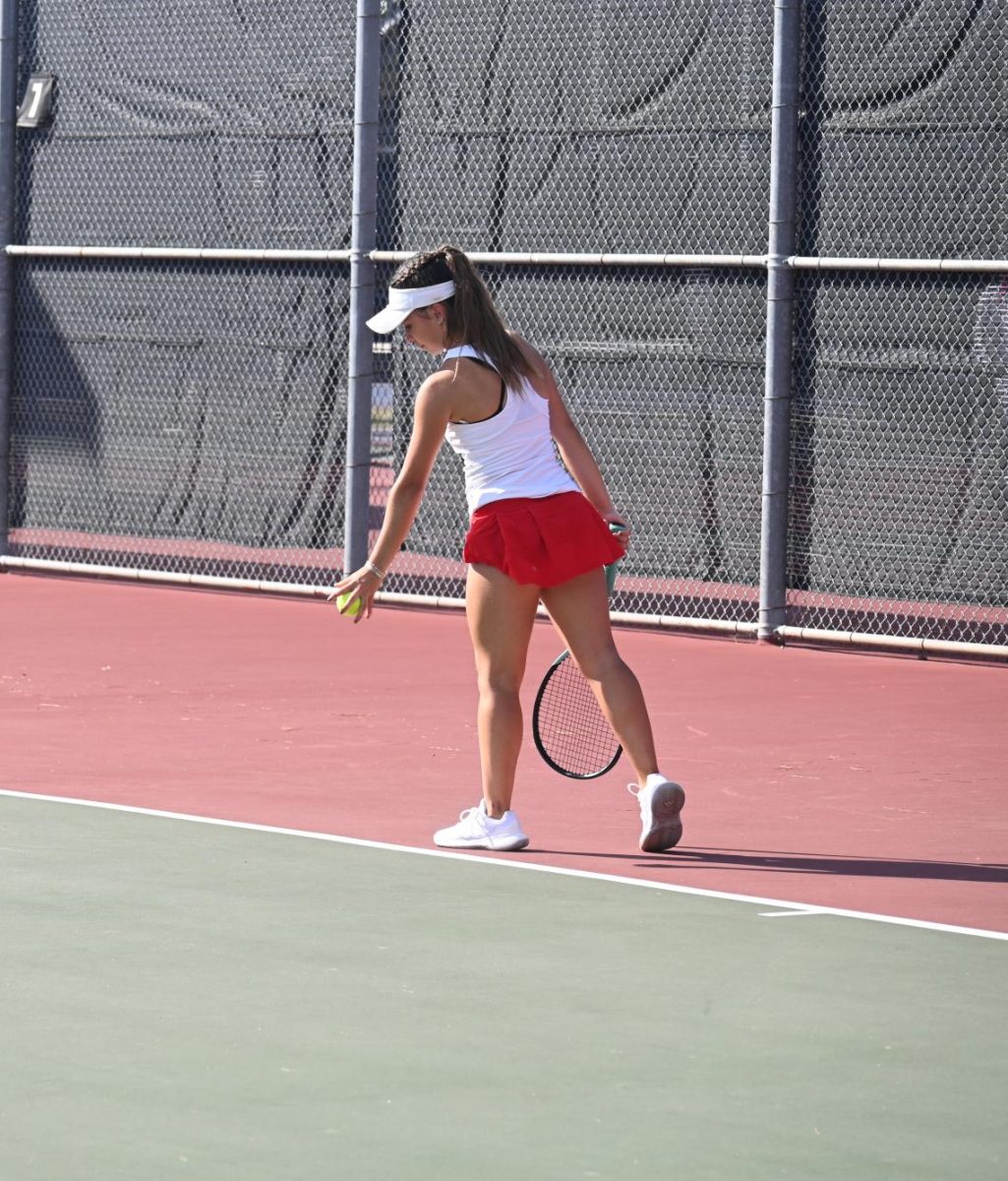 Tomball Tennis girl getting ready to serve.