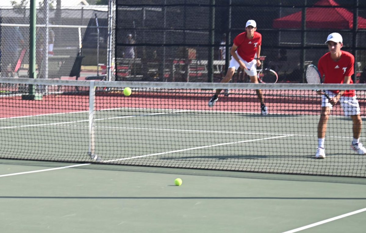 Tomball boys serving with the intention of scoring a point.