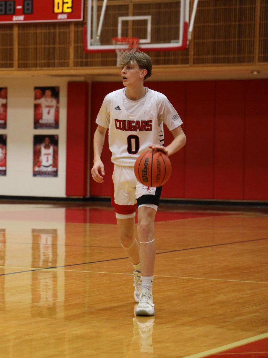 Nate Frazier taking the ball up court to make a play