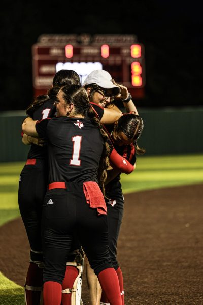 Coach Alyssa Thompson celebrating with her players after the win